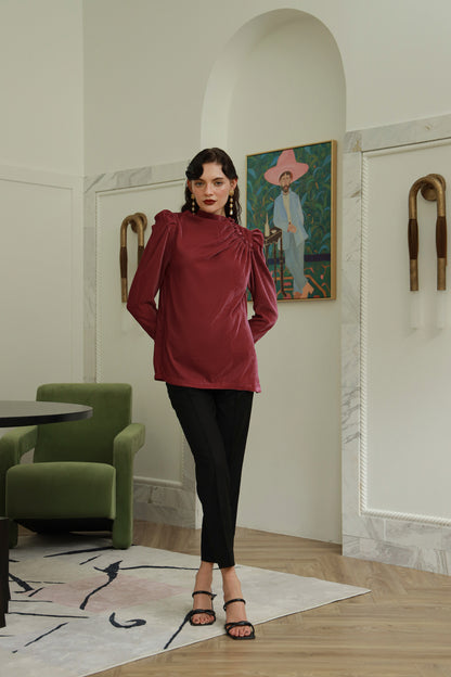 Woman in a red top and black pants